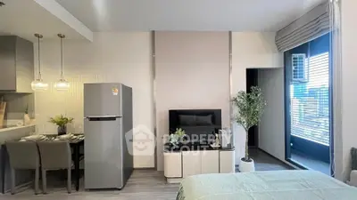 Modern studio apartment with open layout, featuring a sleek kitchen, cozy dining area, and stylish living space.