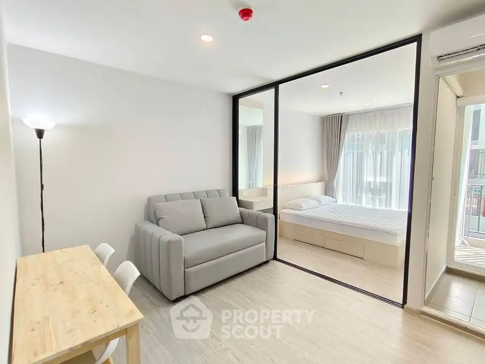 Modern studio apartment with glass partition and cozy furnishings