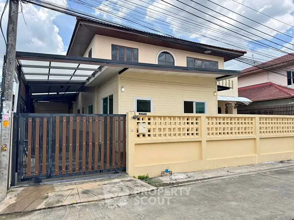 Charming two-story house with gated entrance and spacious driveway in a serene neighborhood.