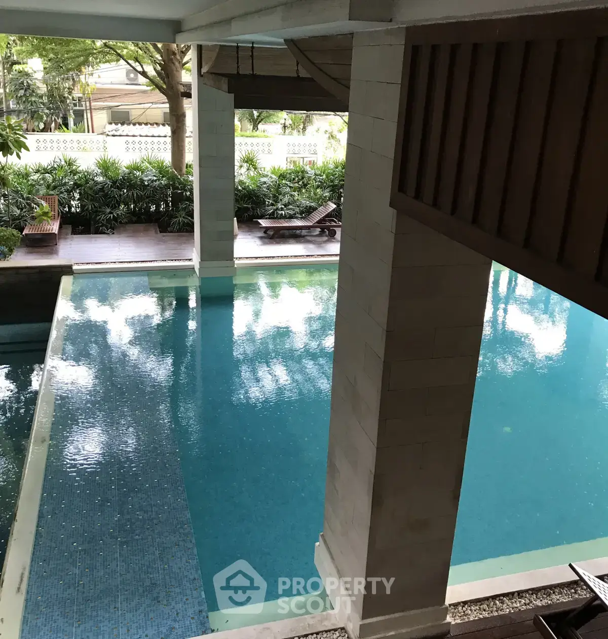 Luxurious pool area with lush greenery and elegant design, perfect for relaxation and leisure.