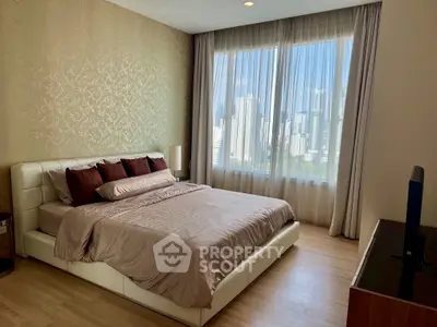 Luxurious bedroom with city view, elegant decor, and natural light.