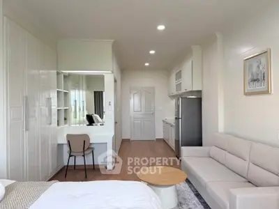 Modern studio apartment with cozy living area and sleek kitchen design