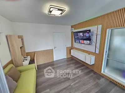 Modern living room with stylish wood paneling and wall-mounted TV