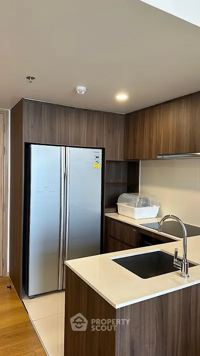 Modern kitchen with sleek wooden cabinets and stainless steel appliances