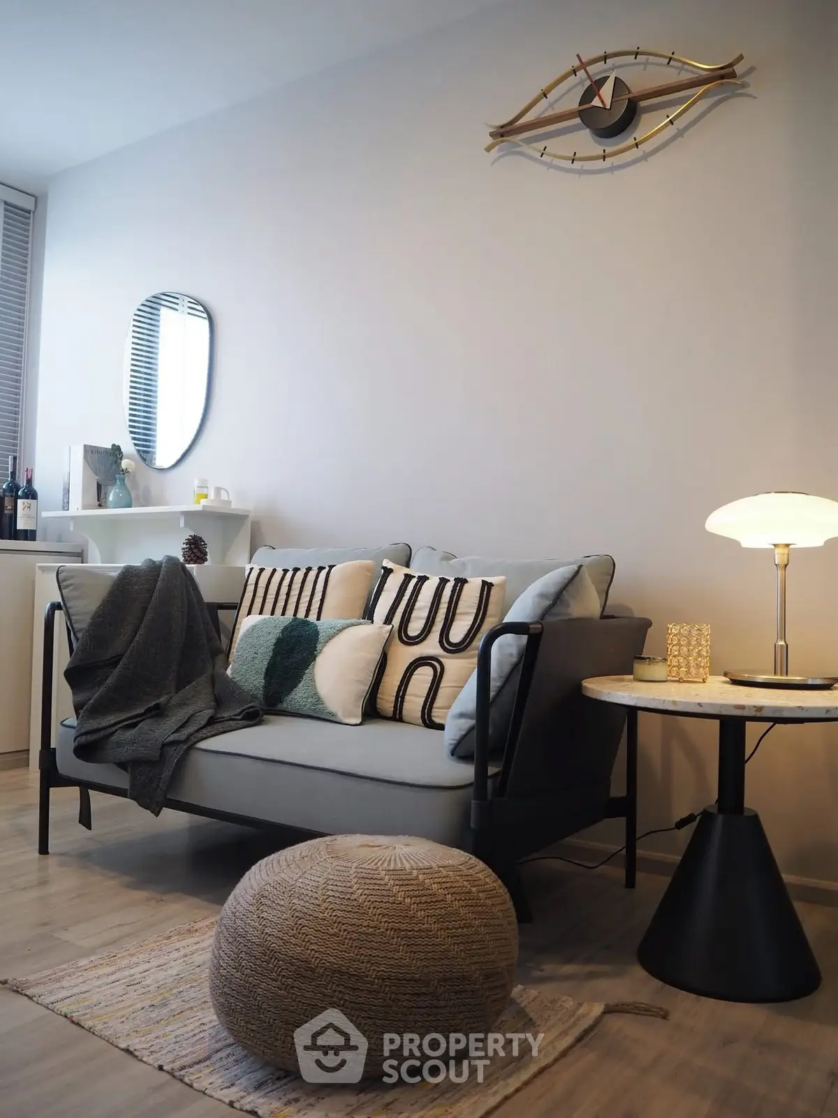 Stylish modern living room with cozy sofa, chic decor, and ambient lighting.