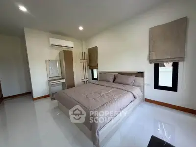 Spacious bedroom with modern decor and natural light
