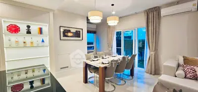 Elegant dining area with modern decor and large windows in a stylish apartment.