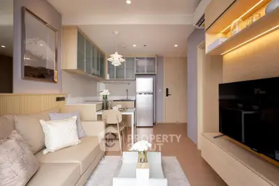 Modern living room with open kitchen, stylish decor, and cozy seating area in a contemporary apartment.