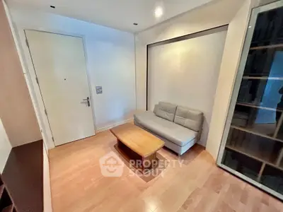 Cozy living room with modern sofa and wooden coffee table, perfect for relaxation.