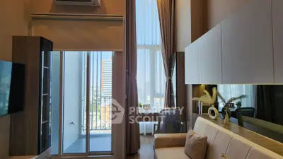 Modern living room with balcony view and stylish decor in high-rise apartment