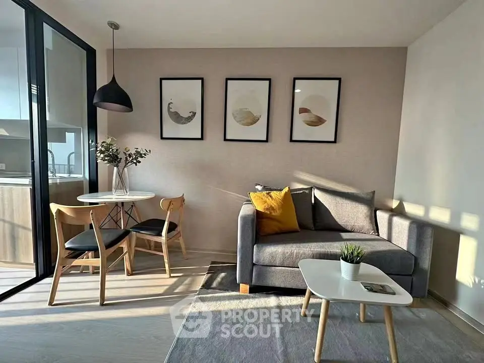 Modern living room with stylish decor and dining area, featuring natural light and contemporary furniture.