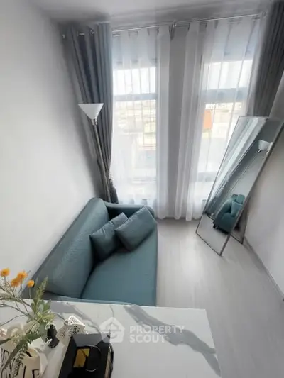 Modern living room with stylish sofa and floor-to-ceiling windows