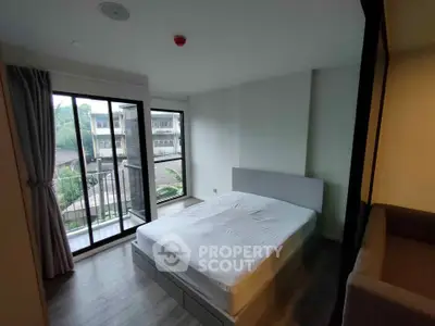 Modern bedroom with large windows and balcony view in a stylish apartment