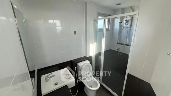 Modern bathroom with sleek fixtures and spacious shower area.