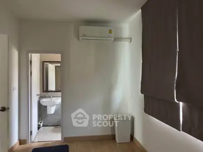 Cozy bedroom with air conditioning and view into modern bathroom