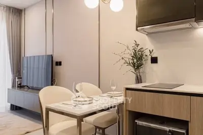 Modern living room with dining area and sleek kitchen appliances