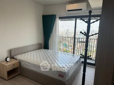 Modern bedroom with city view, featuring a comfortable bed and air conditioning, ideal for urban living.