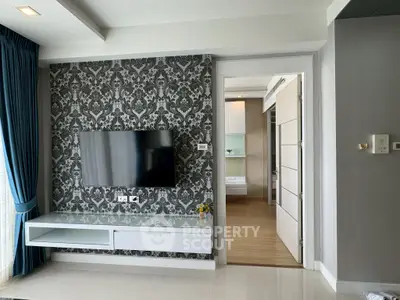 Modern living room with stylish wallpaper and wall-mounted TV, featuring elegant curtains and sleek flooring.