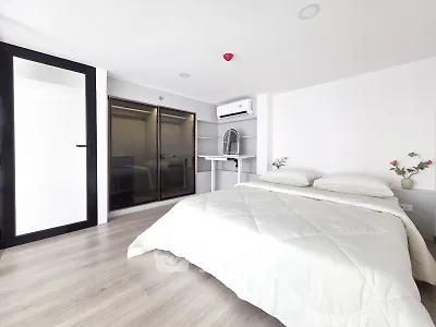 Modern minimalist bedroom with sleek design and ample natural light