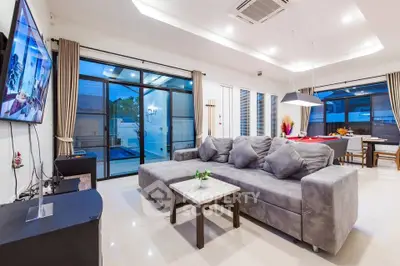 Spacious modern living room with large windows and stylish decor