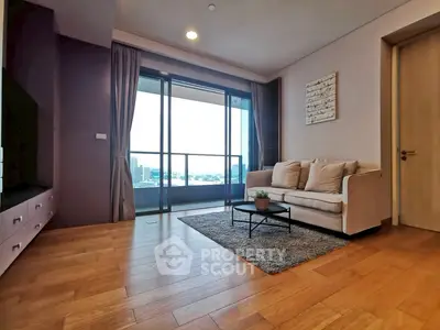 Spacious living room with modern decor and stunning city view balcony.