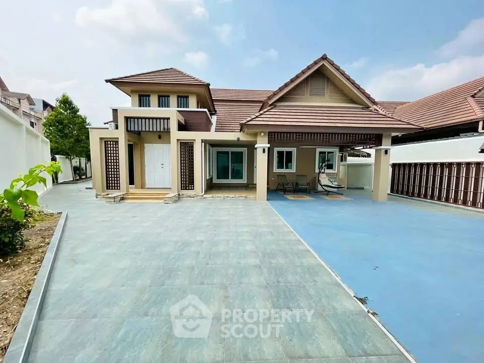 Charming single-story house with spacious driveway and modern architectural design.