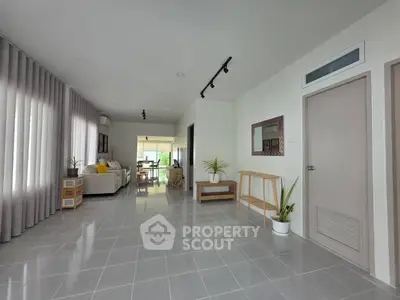 Spacious modern living room with sleek tile flooring and stylish decor