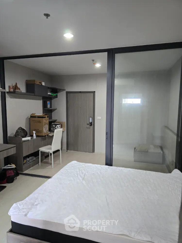Modern bedroom with glass partition and minimalist decor