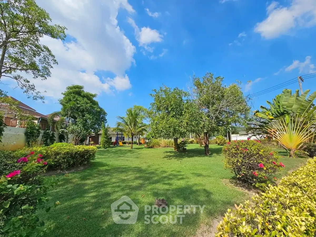 Beautiful garden view with lush greenery and clear blue sky.
