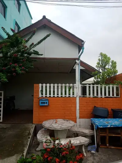 Charming suburban house with brick fence and lush garden