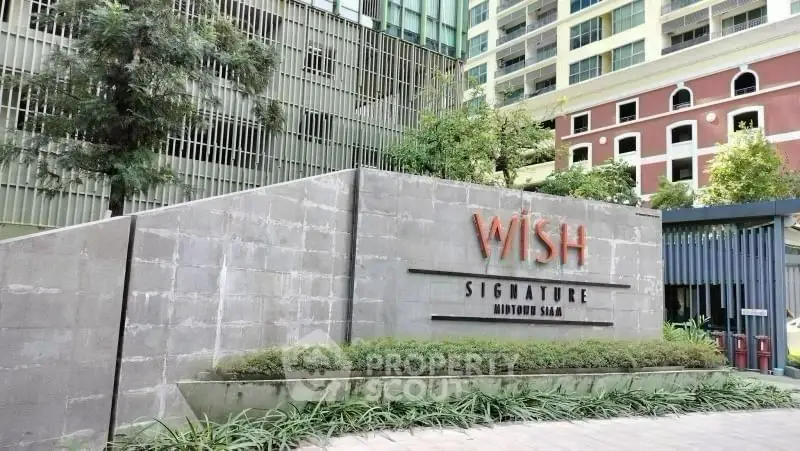 Modern building exterior with Wish Signature Midtown Siam signage and lush greenery.