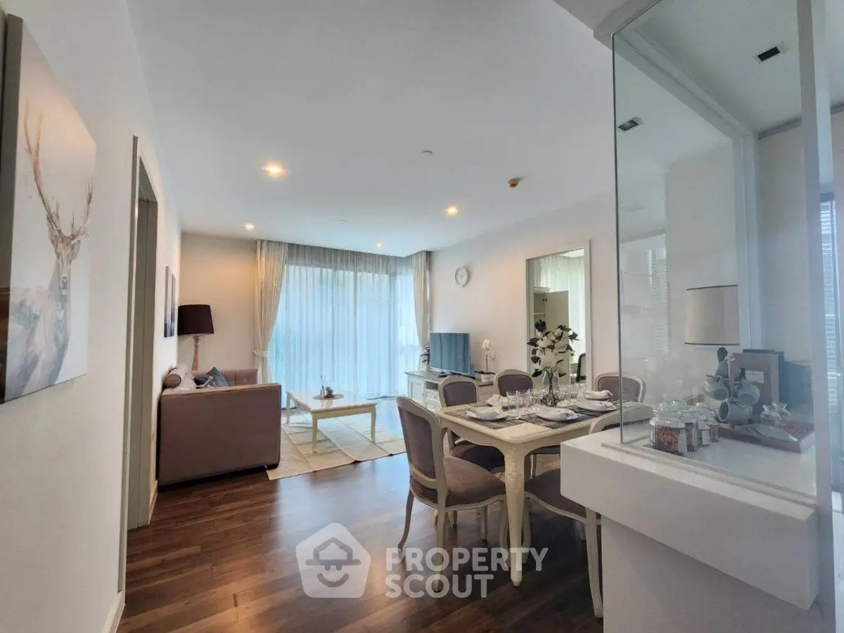 Elegant living and dining area with modern decor and natural light