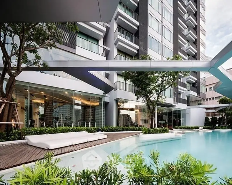 Luxurious modern apartment with stunning pool and lush greenery