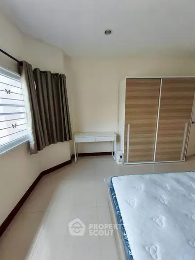 Spacious bedroom with modern wardrobe and natural light