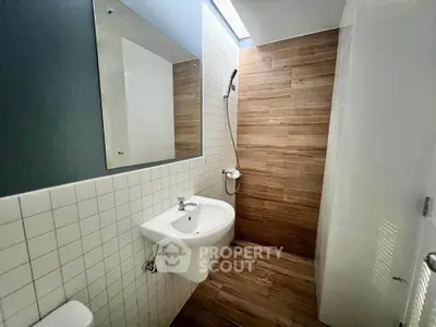 Modern bathroom with sleek design and wooden accents