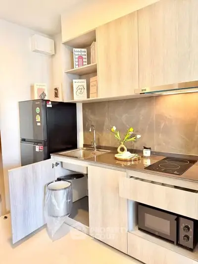 Modern kitchen with sleek cabinetry, built-in appliances, and stylish decor in a contemporary apartment.