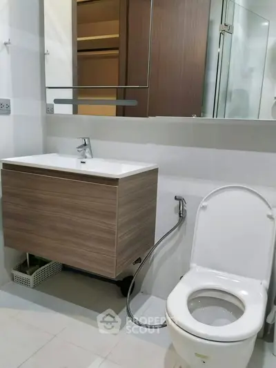 Modern bathroom with sleek vanity and toilet in contemporary apartment.
