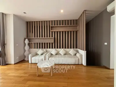Modern living room with stylish wooden accents and elegant white sofa