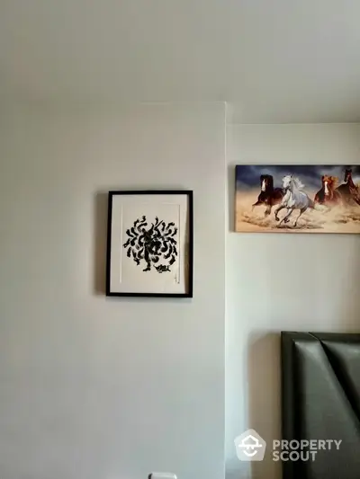 Minimalist bedroom wall with framed art and horse painting