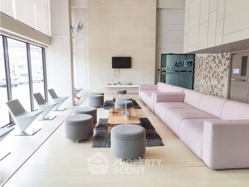 Spacious modern living room with sleek furniture and large windows