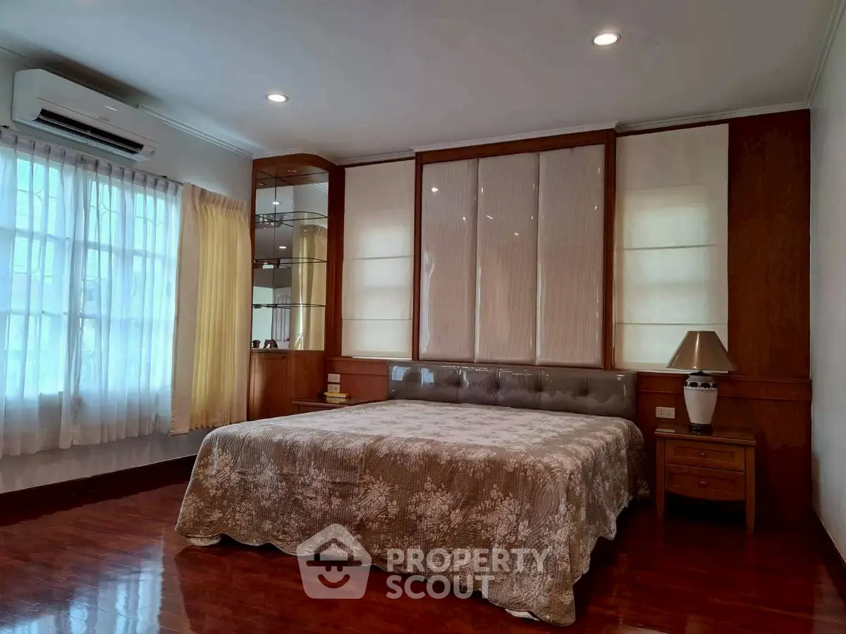 Spacious bedroom with elegant decor and natural light, featuring a comfortable bed and stylish furnishings.