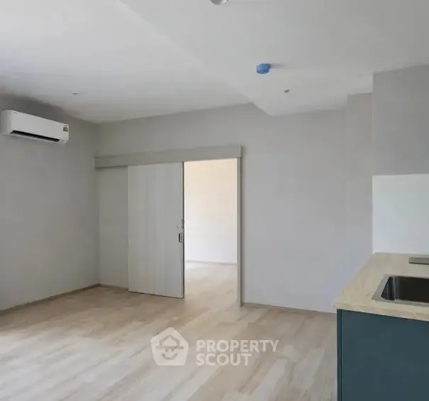 Modern minimalist living room with open kitchen and sliding door