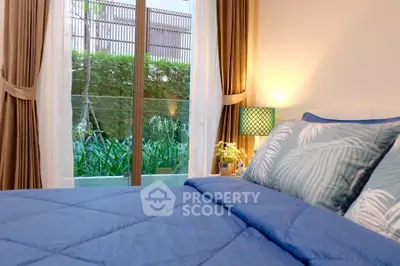 Cozy bedroom with garden view and elegant decor, perfect for relaxation.