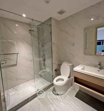Modern bathroom with glass shower and sleek fixtures