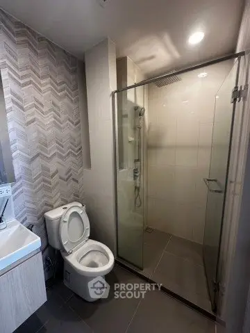 Modern bathroom with glass shower and stylish tile design