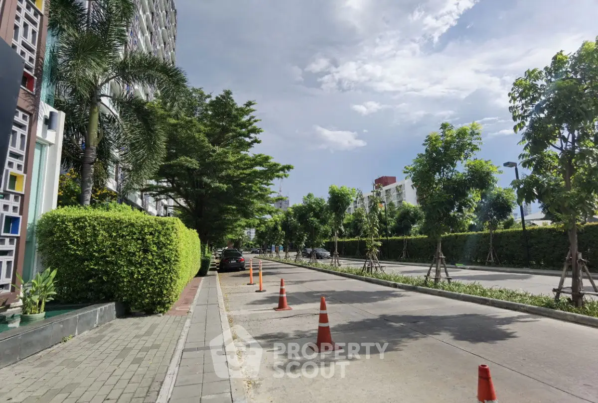 Charming urban street view with lush greenery and modern architecture, ideal for city living.