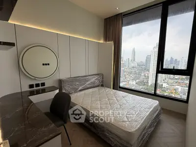 Modern bedroom with city view and sleek furnishings in high-rise apartment