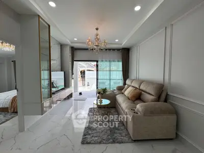 Luxurious living room with elegant chandelier and plush sofa in modern apartment