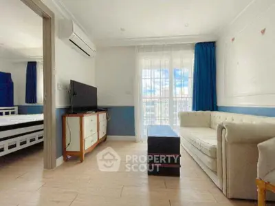 Spacious living room with elegant sofa and large window view