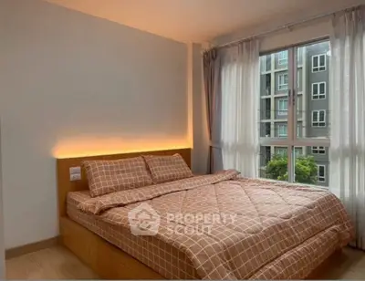 Cozy bedroom with large window and modern decor in urban apartment